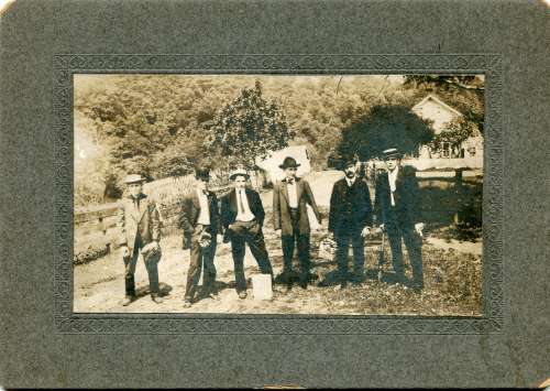 Early Men in Suits Holding Equipment